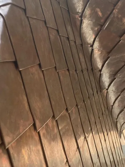 A close-up of the handcrafted copper shingle work from a farmhouse project in Hassan. This detail highlights my commitment to using skilled artisans and natural materials that age gracefully, adding character and warmth to the building over time.