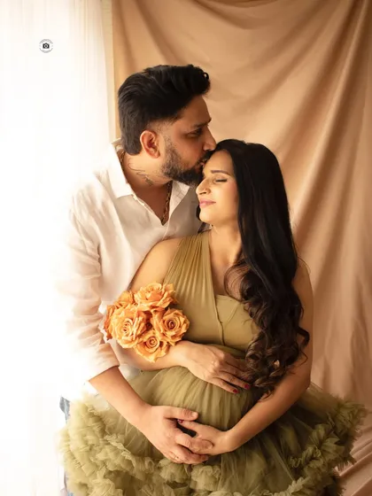 An intimate moment between partners. A gentle kiss on the forehead speaks volumes, capturing the love and support that surrounds this new chapter.