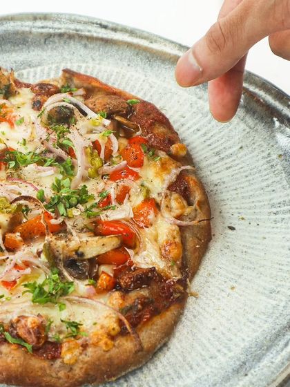 A Guilt-Free Pizza: Confit Garlic and Smoked Mushroom Pizzette: Our pizzette has a crust made from jowar, nachni, and foxtail millet. These ancient grains are gluten-free, low-GI, and packed with fiber, making this a pizza you can feel good about eating.