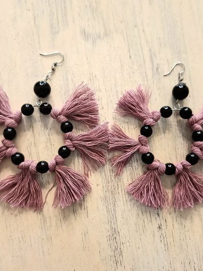 A different take on macrame hoops, this pair features dusty pink tassels and black beads. The contrast between the soft fiber and the smooth beads creates a really interesting texture and look.