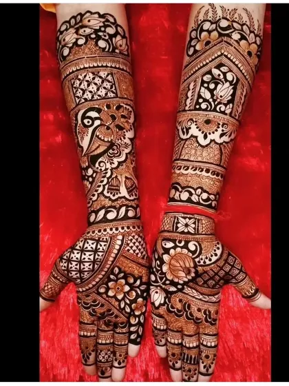 A classic design with a mix of peacocks, flowers, and geometric patterns. The different elements come together to create a full and intricate bridal look.