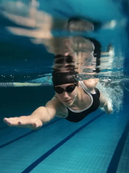 A glimpse of the focus and form you can achieve in our pools. This underwater view shows a swimmer gliding through a clearly marked lane, perfect for concentrating on stroke technique and lap swimming efficiency.