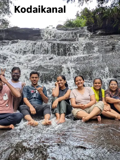 Taking a refreshing break at a waterfall in Kodaikanal. It's the perfect way to cool down and have some fun during a day of sightseeing.