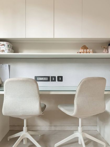 We designed this shared study area for two brothers, with ample desk space, overhead storage, and comfortable chairs to create a perfect spot for homework and creative projects.