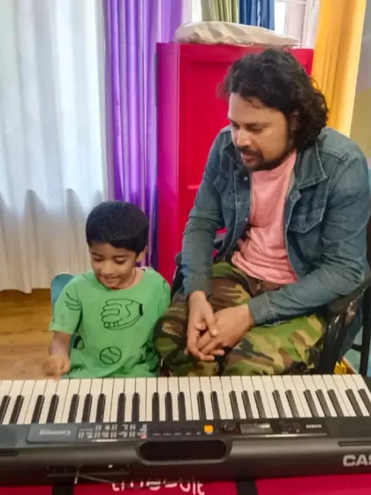 A moment of connection between teacher and student. I believe in giving personalized attention to help each child, like this young learner, feel comfortable and curious at the piano.