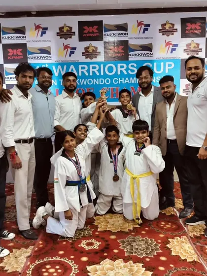 The entire team celebrating with the trophy at the Warriors Cup. We win as a team and celebrate as a family.
