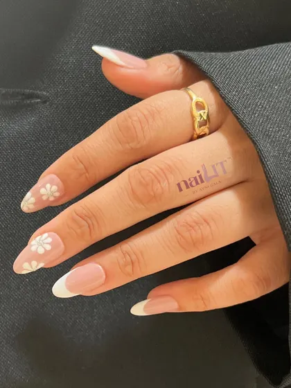 Another beautiful shot of the French manicure with daisy accent nails. This is a perfect example of a simple yet personalized and elegant design.