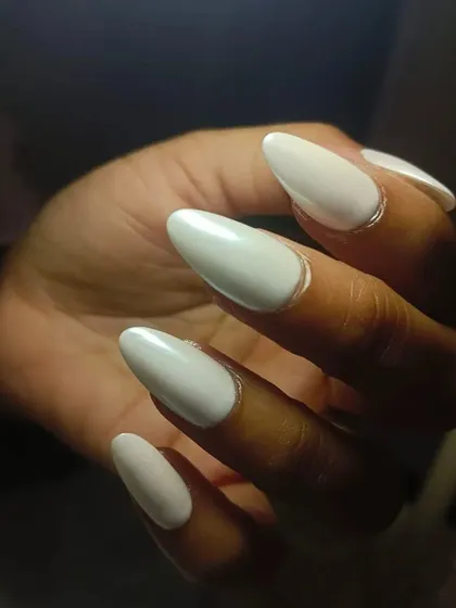 A close-up of the glazed nails, showing the smooth, pearlescent finish on the almond-shaped extensions.