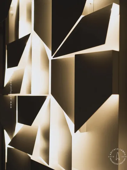 A close-up, angled view of the geometric puzzle wall light. This perspective highlights the depth and complexity of the design, showing how the light emanates from within the structure to create a soft, diffused effect.