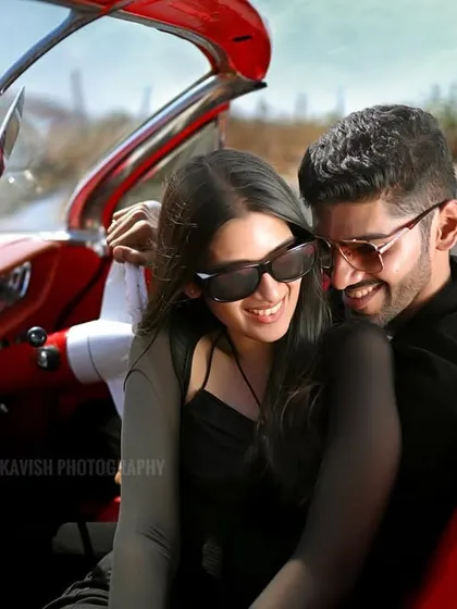 A happy, relaxed moment between the couple in the front seat of the classic car. This pre-wedding photo feels natural and unposed, focusing on their genuine smiles.
