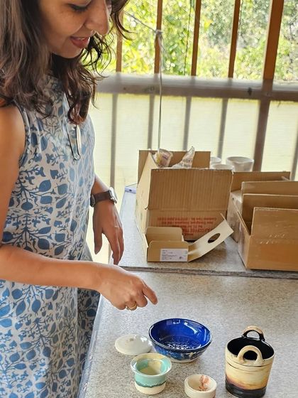 The priceless expression of a student seeing her finished, glazed pieces for the first time. It makes all the hard work worth it.