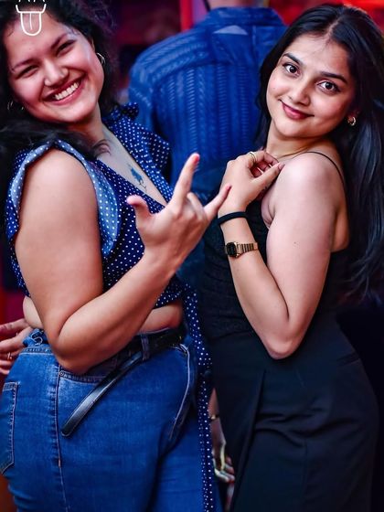 Rocking the party with a fun hand gesture. The crowd at The Fixx is always interactive and full of life.