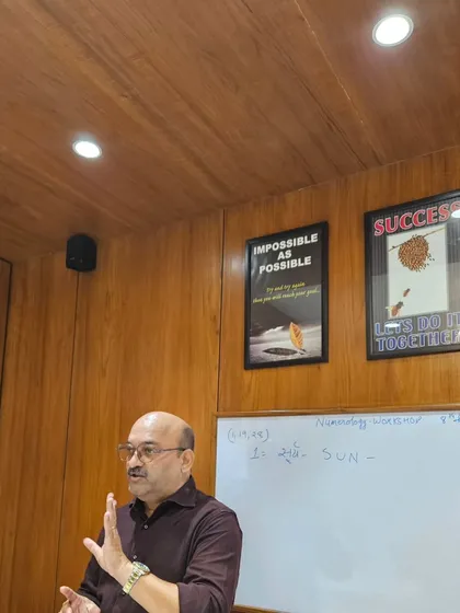 Teaching the fundamentals of numerology, explaining the attributes of each number from 1 to 9, during a workshop in my Surat office.