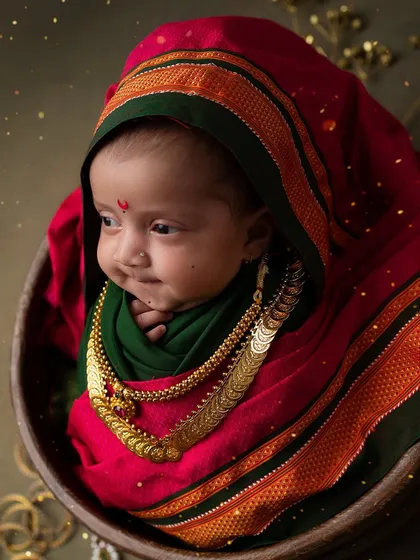A curious glance from our tiny Maharashtrian beauty. Her delicate features and the rich colors of the saree create a stunning, culturally rich portrait.