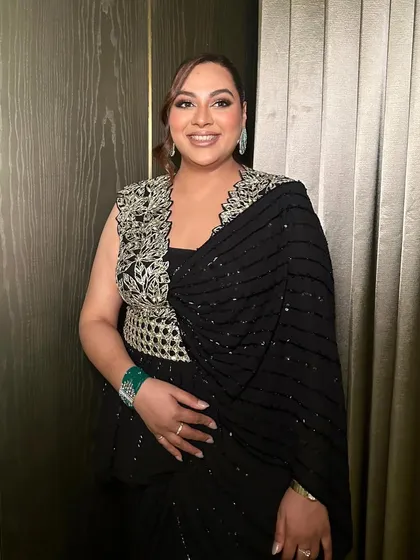 A smiling shot of this cocktail glam, showing how the makeup looks both beautiful and natural, even with a defined eye.