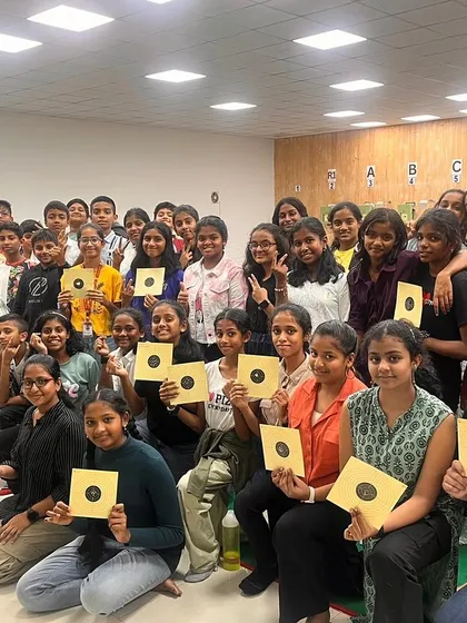 All smiles after a successful session. A large group of students from Carmel Academy proudly display their first targets during a Children's Day event at our academy.