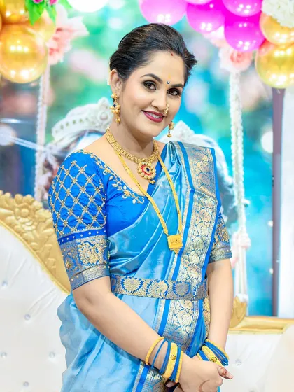 The full look, showing how the vibrant blue saree and traditional styling create a memorable look for a very special day.