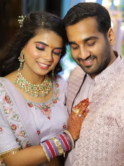 A beautiful couple during their engagement ceremony. For the bride, I created a soft glam look with shimmery lavender eyeshadow and a natural lip color to perfectly match her pastel lehenga, ensuring she looked radiant throughout the event.