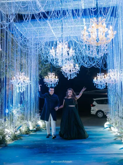 The entrance to an unforgettable night. We designed this tunnel of cascading crystals and chandeliers to create a dramatic, immersive welcome for the couple, setting the tone for a Sangeet that was pure magic.