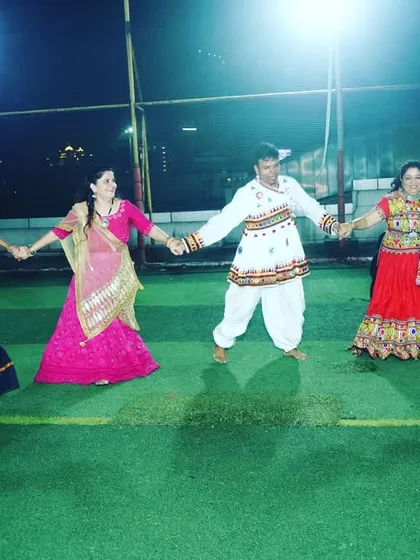 The joy of dancing together. A candid moment from our Garba night where students and instructors join hands to dance in a circle.