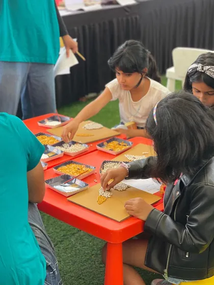 Our creative workshops are a place for little artists to shine. I provide all the materials for activities like this grain art session, allowing kids to explore their creativity freely while you shop. It's wonderfully chaotic and so much fun to watch.