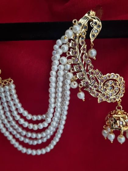 The 'किमाया' (Kimaya) earcuffs with multi-strand pearl earchains. This piece combines the elegance of a jhumka with the grandeur of a full earcuff and sahara chain.