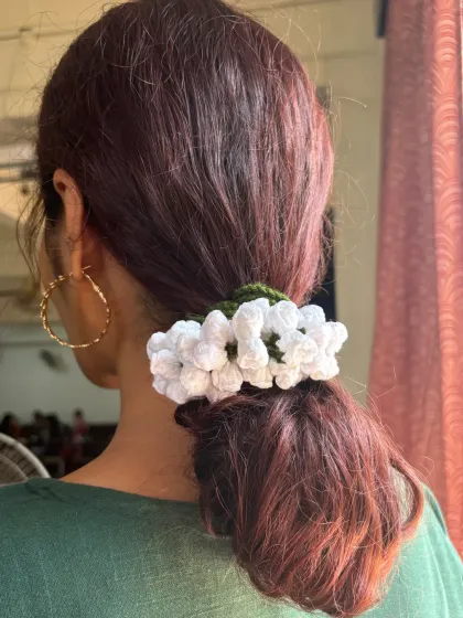 This is my handmade crochet gajra, a modern twist on a classic hair accessory. I love how it looks in a simple ponytail, adding a touch of timeless elegance that, unlike real flowers, will last forever.