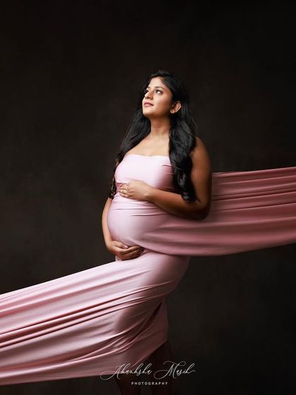 A powerful pose with a simple pink fabric drape, looking upwards with a sense of hope and strength.