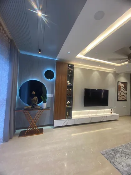 We love adding unique design touches that reflect our client's personality. In this living room, we combined a textured accent wall, a floating marble-finish TV unit, and creative backlighting to create a sophisticated and memorable entertainment space.