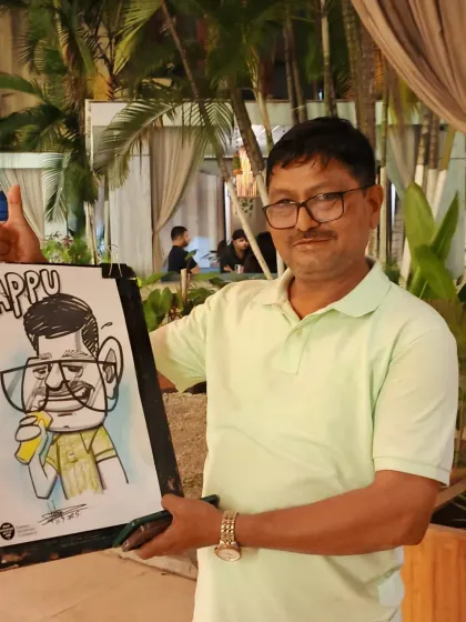 An older gentleman with his caricature, which includes his name, 'Appu'. Personalizing the drawings makes them extra special.