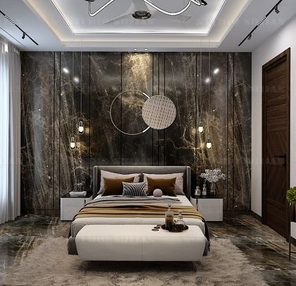 A bedroom in Varanasi with a dramatic, dark marble accent wall. The circular, woven light fixture adds a soft, organic contrast to the hard stone.