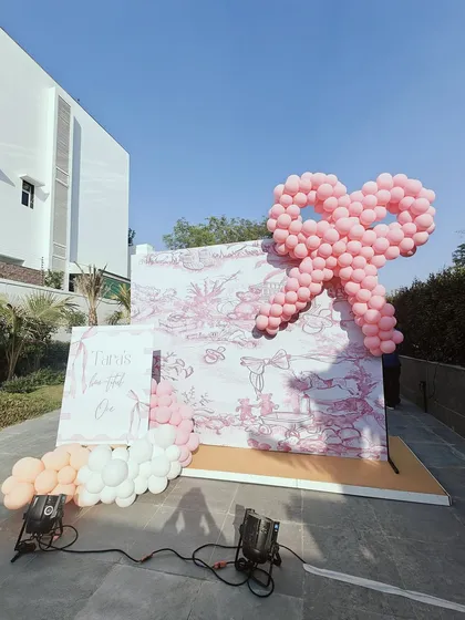 A different angle of the bunny-themed party, showing a large pink balloon bow as a standalone decor piece. This demonstrates how we use creative balloon sculptures to enhance the theme throughout the event space.