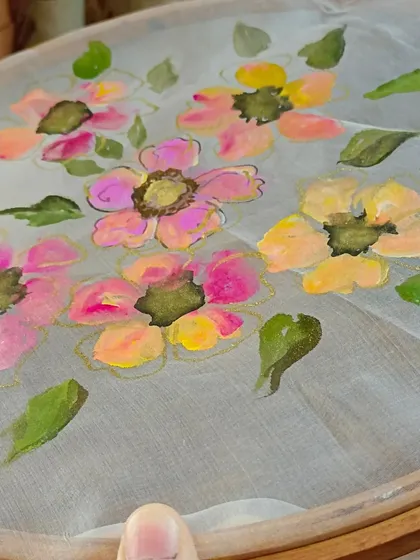 A work-in-progress shot of floral fabric painting. Our professional courses for boutique owners and designers cover techniques for creating hand-painted clothing collections.