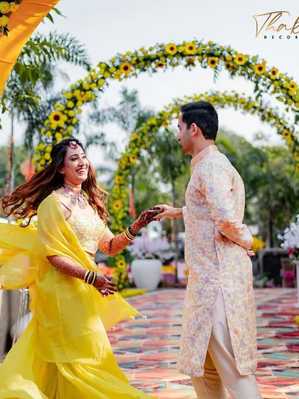 The entry to this Haldi celebration was designed with a series of floral arches, creating a beautiful, immersive walkway for guests. The vibrant yellow sunflowers set a cheerful and welcoming tone.