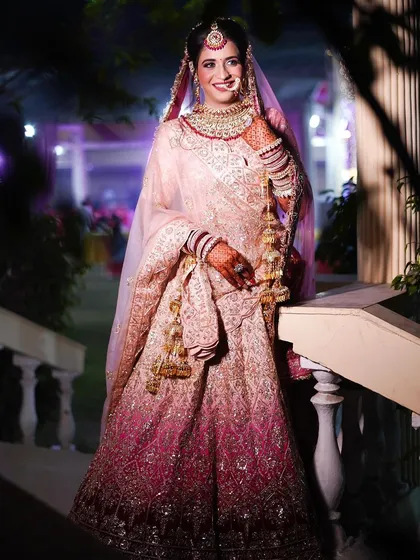 A happy bride in her beautiful pink ombre lehenga. She looks so joyful and radiant.