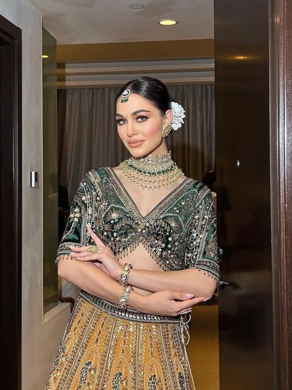 A modern bridal look in a unique combination of green and gold, perfect for a Mehendi or Sangeet.