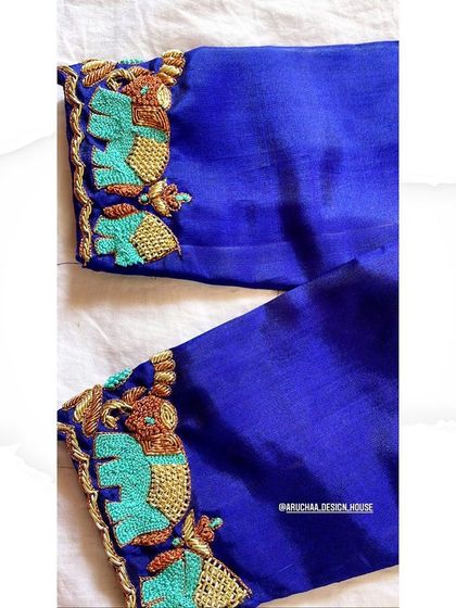 A custom royal blue blouse with zardosi embroidery highlighting an elephant motif on the sleeve.