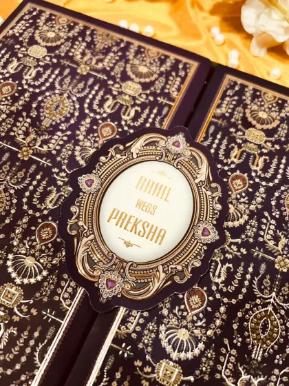 This design is pure opulence. I chose a deep aubergine velvet finish and paired it with intricate gold foil work inspired by royal tapestries. It's an invitation that feels as rich and special as the bond it represents.