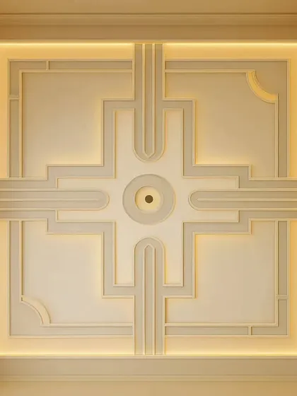 A perfect example of a modern, elegant false ceiling. This design uses clean geometric lines and warm, hidden cove lighting to give the room a sophisticated feel without being overpowering.