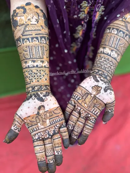 This bridal mehendi is a story in itself, featuring portraits and scenes from wedding rituals. The design extends up the arms with bands of elephants and intricate patterns.