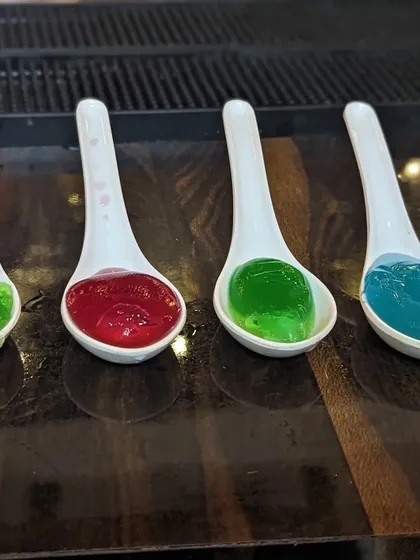 We even make edible cocktails. These colorful jelly spheres are a fun and unique way to serve drinks, offering a surprising burst of flavor.