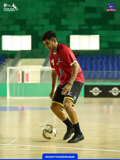 Dribbling with focus during the pre-match warm-up.