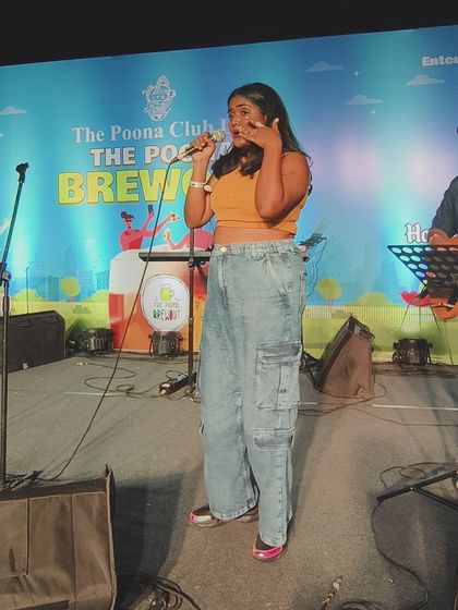 A wide shot showing the stage setup and my interaction with the space. I use the whole stage to connect with everyone in the audience, no matter how big the venue.