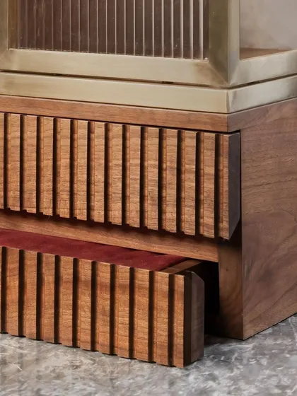 Details are the language of quality. Here, you see the precise fluting on a solid wood drawer, which opens to reveal a rich, red velvet lining. It is these hidden moments of craftsmanship that define our approach to bespoke furniture design.