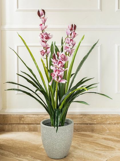 These delicate pink artificial orchids bring a touch of elegance and sophistication to any setting. The lifelike flowers and green leaves provide a lasting floral display without any fuss.