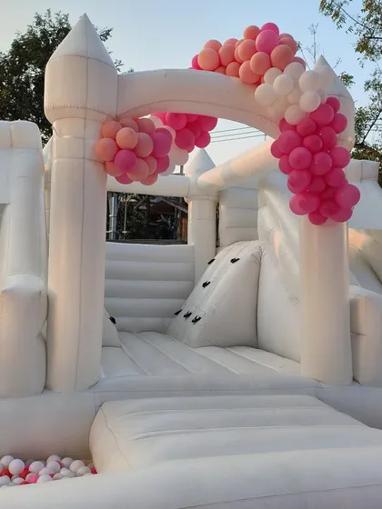 Adding to the fun of a teddy bear party, this all-white inflatable bounce house castle provides entertainment for the kids. We decorated it with a simple pink balloon garland to tie it into the overall theme.