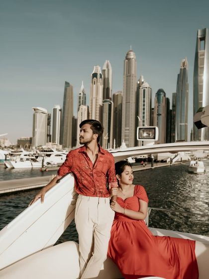 A stylish portrait on a yacht, with the couple looking out towards the Dubai Marina skyline.