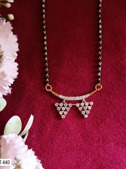 A duplicate of the geometric mangalsutra design, this piece features two small triangles made of American diamonds. It's a chic and minimalist choice.