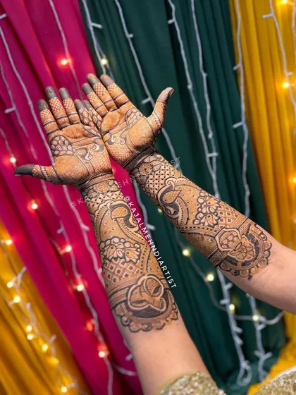 This bridal design features graceful peacocks on the palms and intricate bands extending up the arms.