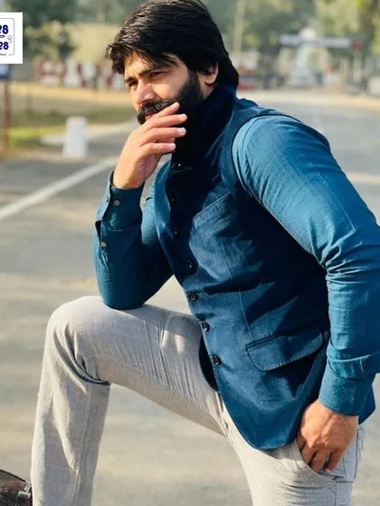 A simple and smart look for any occasion. This client is wearing a solid blue Nehru jacket over a formal shirt, a great example of versatile semi-formal wear that we tailor at your doorstep.